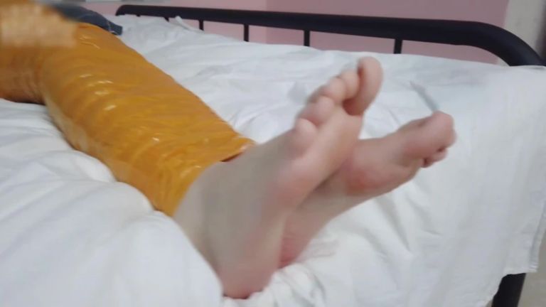 First-person Perspective Records the Girlfriend Wrapped in Tape From Head to Toe with Her Beautiful Bare Feet